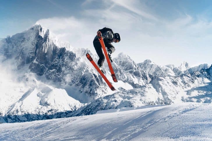 Man with orange skis