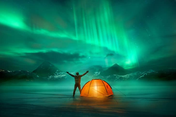 Man looking at Northern Lights in travel destination